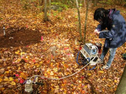 Hui-Ju Wu uses a commercial soil flux chamber in a rain simulation experiment, Harvard Forest, Massachusetts
